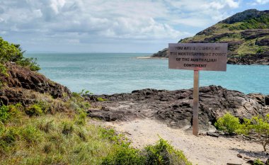 Tip of Cape York Peninsula with a sign saying you are at the tip looking towards the Torres Strait clipart