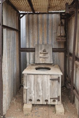 a view inside a old Australian dunny with a red back spider on the open lid clipart