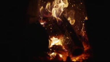 Sparks appearing from stirring firewood in an old rustic stove