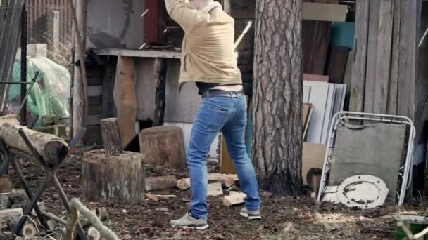 Guy Cuts Wood Backdrop Outbuildings Barn — Stockvideo