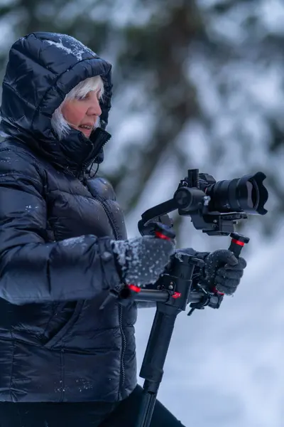 Woman Winter Clothes Holds Stabilizer Both Hands Watches Video Recording Royalty Free Stock Images