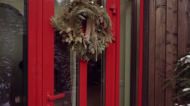 家の玄関にぶら下がっているクリスマスリース — ストック動画
