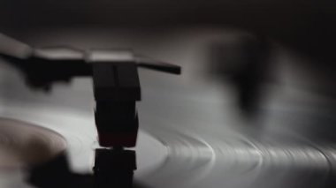 Çalınan vinil plağın sonuna ulaşan gramofon iğnesinin yakın çekimi.
