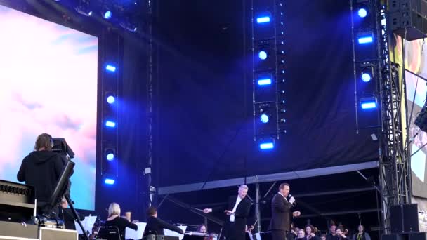野外ステージでは ソリストがオーケストラと一緒に歌を歌い 花火や観客の拍手で終わると ハンドヘルドショット — ストック動画