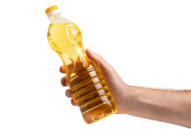 A bottle of golden sunflower oil in the hand. Product on a white isolated background without a label. Sunflower oil is from the seeds of sunflower. clipart