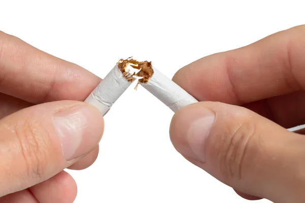 Stock image Man trying to quit smoking. Broken cigarette. Conceptual image. Close-up