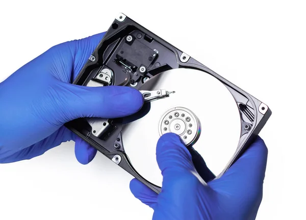 Repair Hard disk. Hands of master in gloves repair the computer hard drive. Data cleaning, HDD recovery