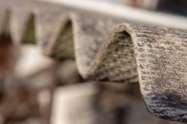 Roof of a country house, covered with gray slate, close-up. Old roof covered with slate. Texture of old roof, slate background.