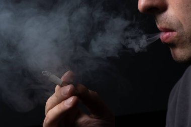 genç adamın elinde Sigara İçilmeyen yakın çekim.