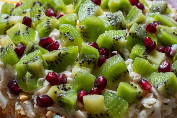 Healthy fruit salad kiwi and pomegranate background.