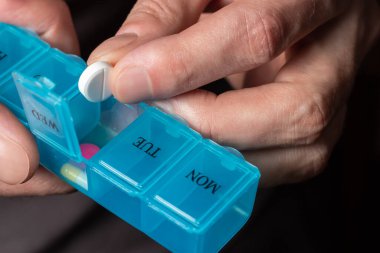 Man take pills from box. Healthcare and old age concept with medicines. Medicaments on table