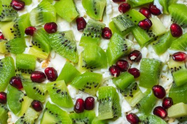 Healthy fruit salad kiwi and pomegranate background.