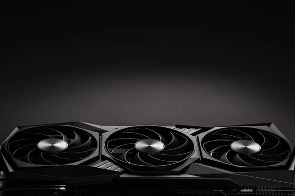 video card with three coolers from the computer on a dark background.concept computer harware