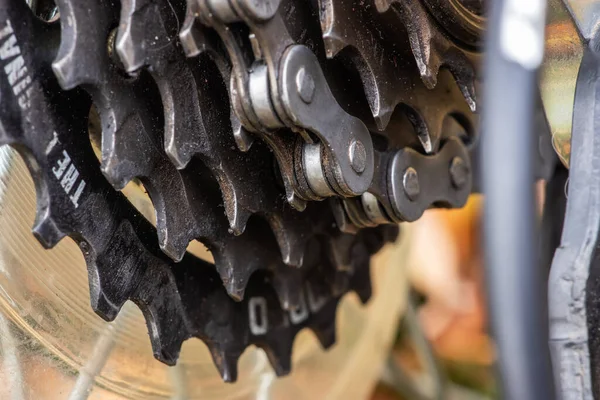 Dirty bicycle drivetrain. Gravel Bike Transmission in Mud. Dirty Chain Drive of Mountain Bike After Riding in Bad Weather. Concept of bike service after riding outdoors on a rainy day.
