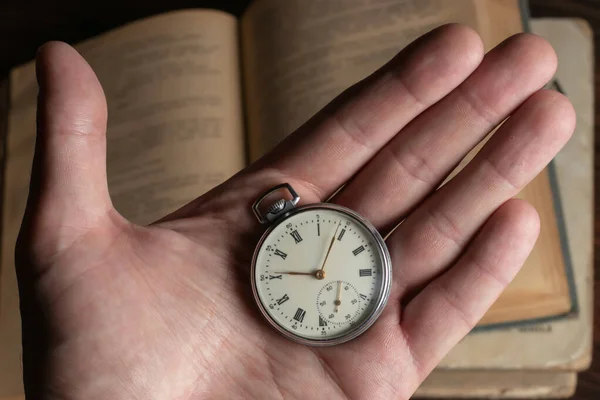 pocket watch in the hands of a man.