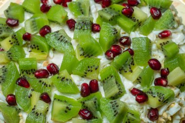 Healthy fruit salad kiwi and pomegranate background.