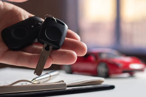 Business concept, car insurance, sell and buy car, car financing, car key for Vehicle Sales Agreement. New carowners are taking keys from male salespeople.