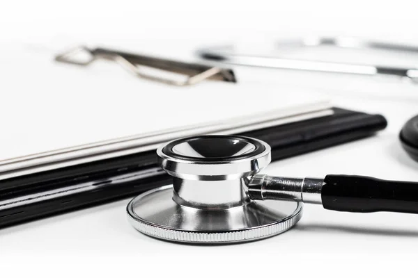 stock image Stethoscope laying on patient information blank close up