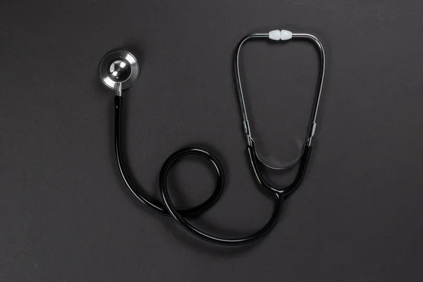 stock image top view of stethoscope on gray surface.