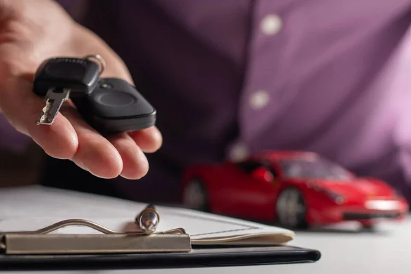 Business concept, car insurance, sell and buy car, car financing, car key for Vehicle Sales Agreement. New carowners are taking keys from male salespeople.