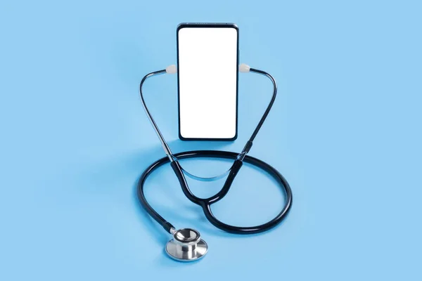 stock image Online doctor. Mobile phone mockup for medical app. Smartphone white screen mockup and stethoscope for health application. App health phone mockup. Banner with copy space