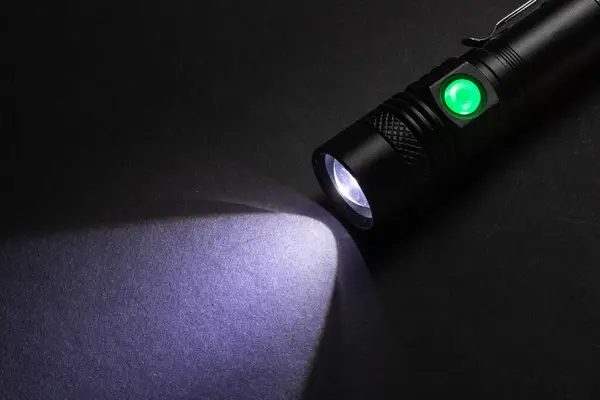 Closeup pocket LED flashlight on dark background