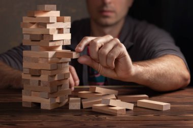 Planlama, risk ve iş, iş adamı ve mühendis bir kule üzerinde ahşap blok yerleştirme kumar strateji.
