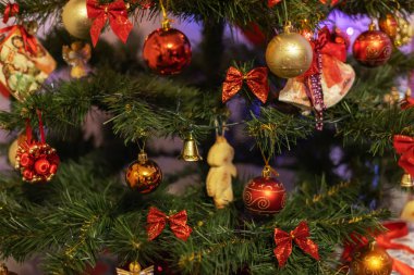 Yeni yıl oyuncağı. Bulanık, ışıl ışıl ve muhteşem bir arka planda dekore edilmiş Noel ağacı. Garland ve Bokeh. Parlak Işıklar. odağını kaldır