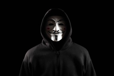 Dinyeper. Ukrayna 31 Ocak 2024: Siyah arka planda kapüşonlu kan davası maskesi giyen adam. Bu maske Anonim Hackerlar grubunun ve hükümetlere karşı ayaklanmaların sembolü.