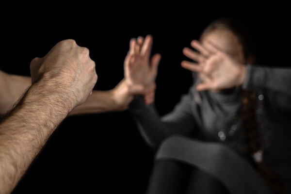 Father beating up his child. Domestic violence concept.