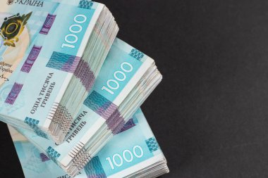 Masada bir paket Hryvnias var. Finansal konsept. Ukrayna parası. Koyu arkaplanda 1000 hryvnia
