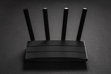 Modern stylish Wi-Fi router on a dark background. Organization of wireless networks. clipart