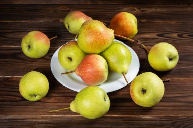 Tahta masadaki tabakta taze armut meyvesi. Sağlıklı meyve.