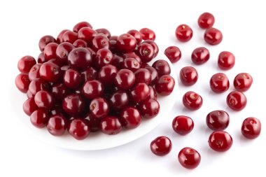 Beyaz arka planda izole edilmiş tabakta olgun kırmızı kirazlar.