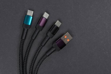 USB type A, USB type C cable isolated on dark background. clipart