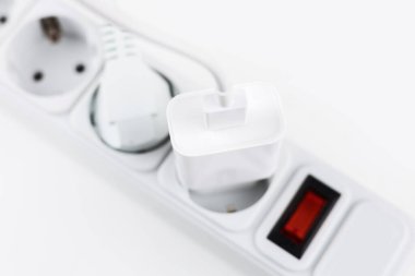 mobile phone chargers connected to electrical power strip. Various devices charging concept,