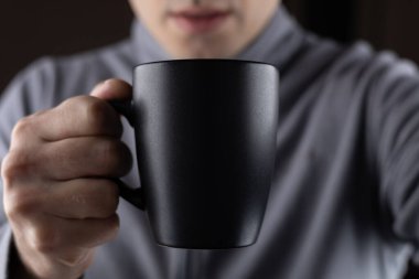 Siyah bardağı arka planda tutan adamlar, yakın plan..