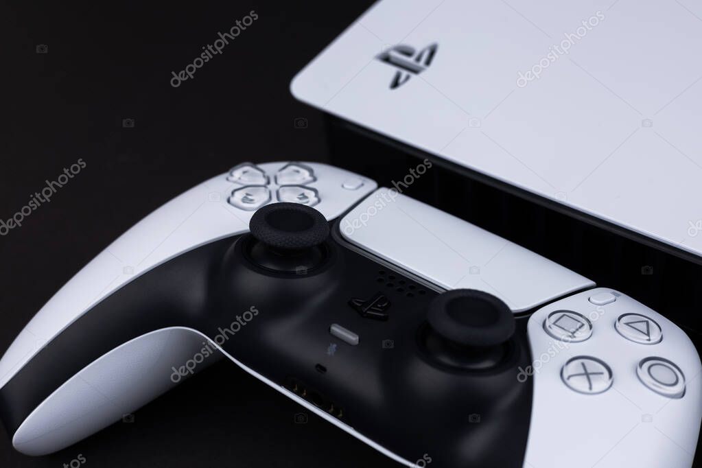 Dnipro Ukraine - dec 29, 2024: New Playstation 5 slim models and controller on black background.