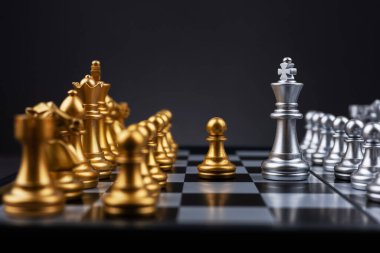 Kral gümüş satranç, altın satranç takımının karşısında duruyor. Satranç tahtası iş fikirleri ve rekabet ve strateji planı kavramı başarı anlamına gelir