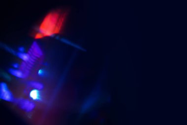 Bulanık neon ışık. Mercek alevi kaplaması. Bokeh floresan flaş parıltısı. Koyu siyah soyut arkaplanda odaklanmış mavi mor renk lekeleri.