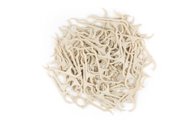 Çevre dostu mısır nişastalı diş kürdanı ve beyaz arka planda diş ipi..