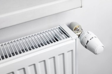 Thermostatic head and radiator valve. Energy saving and save money concept. Reduce consumption of gas or electricity.