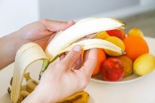 Fruit cleaning. Avitaminosis.man peeling a banana