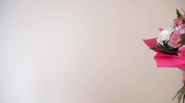 a man gives a woman flowers on a white background. Holidays, congratulations of women, date