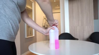 a woman cannot open a chemical pipe cleaner. Protective covers from children. Chemicals. High quality 4k footage