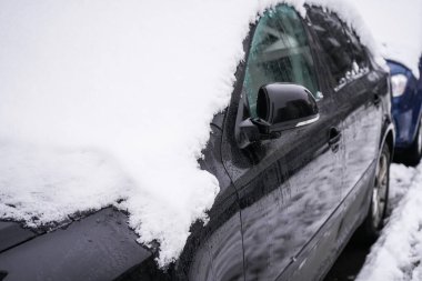 car with snow on it. Snow removal from the car, winter weather