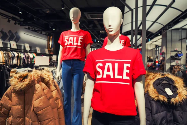 Mannequins in a red t-shirt with the inscription sale in the mall. High quality photo