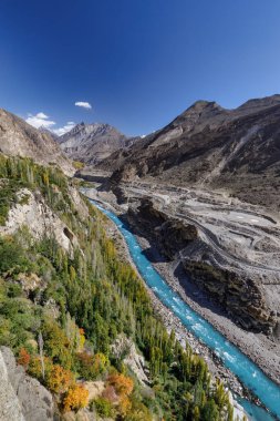Hunza Nehri 'nin sonbahar manzaralı mavi suları, arka planda sıradağlar, Hunza, Pakistan.