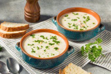 Homemade Creamy Clam Chowder Soup with Bread and Parsley clipart