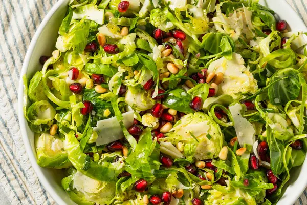 Raw Organic Brussels Sprouts Salad with Cheese and Pomegranate